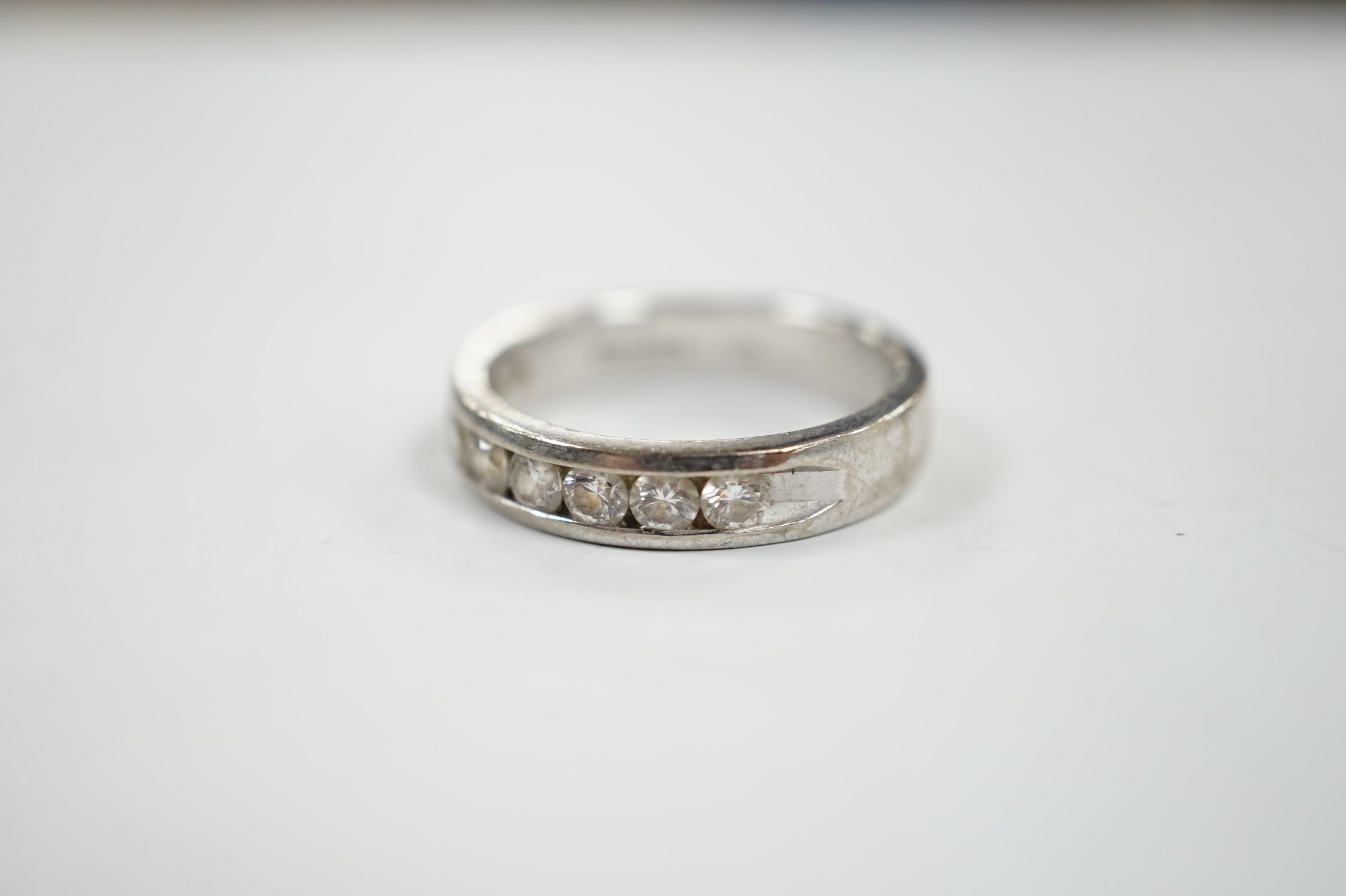 A modern Iliana 18ct white gold and nine stone channel set diamond half eternity ring, size R, gross weight 7.7 grams.